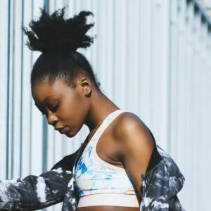 Fitted sports crop top with blue and pink tie-dye pattern.